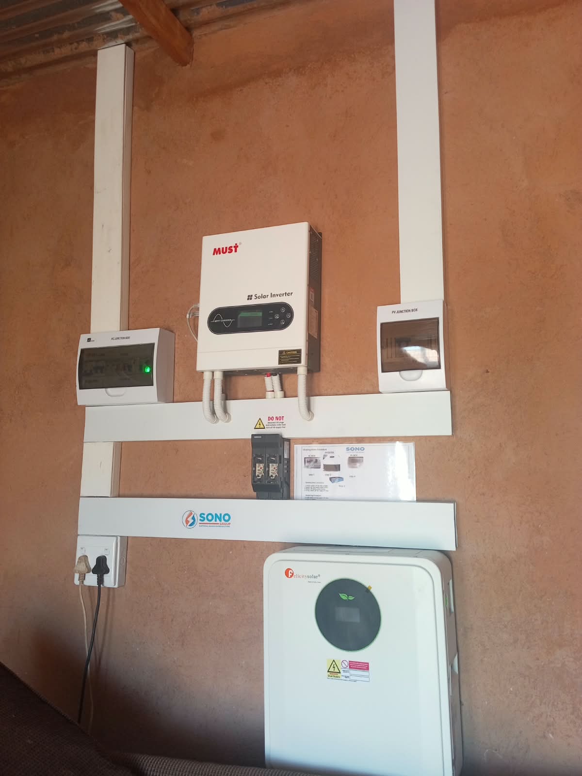 Newly installed heat pump water heating system on an outside wall