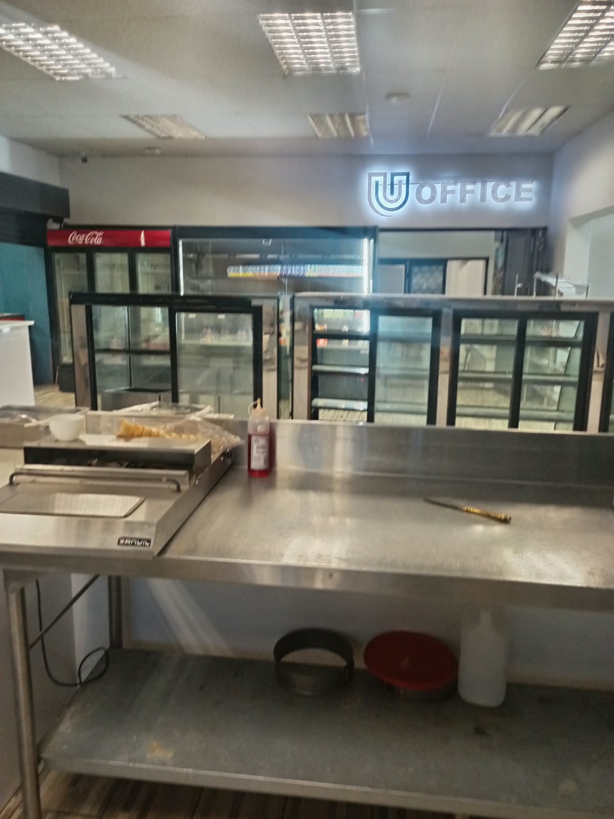 Commercial kitchen with stainless steel counter fridges