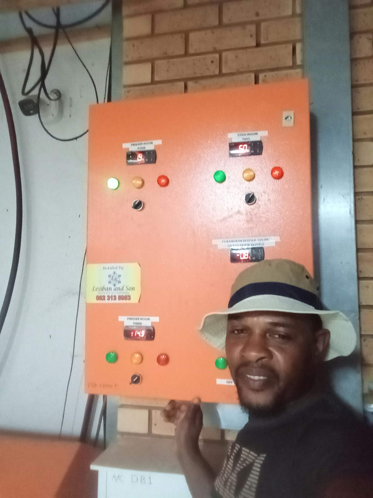 Technician working on an industrial electrical control panel